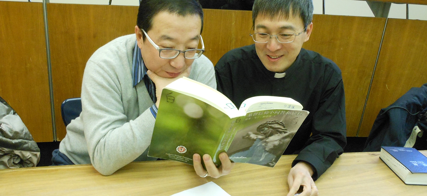 Chinese Men Studying Chinese Luther's Small Catechism