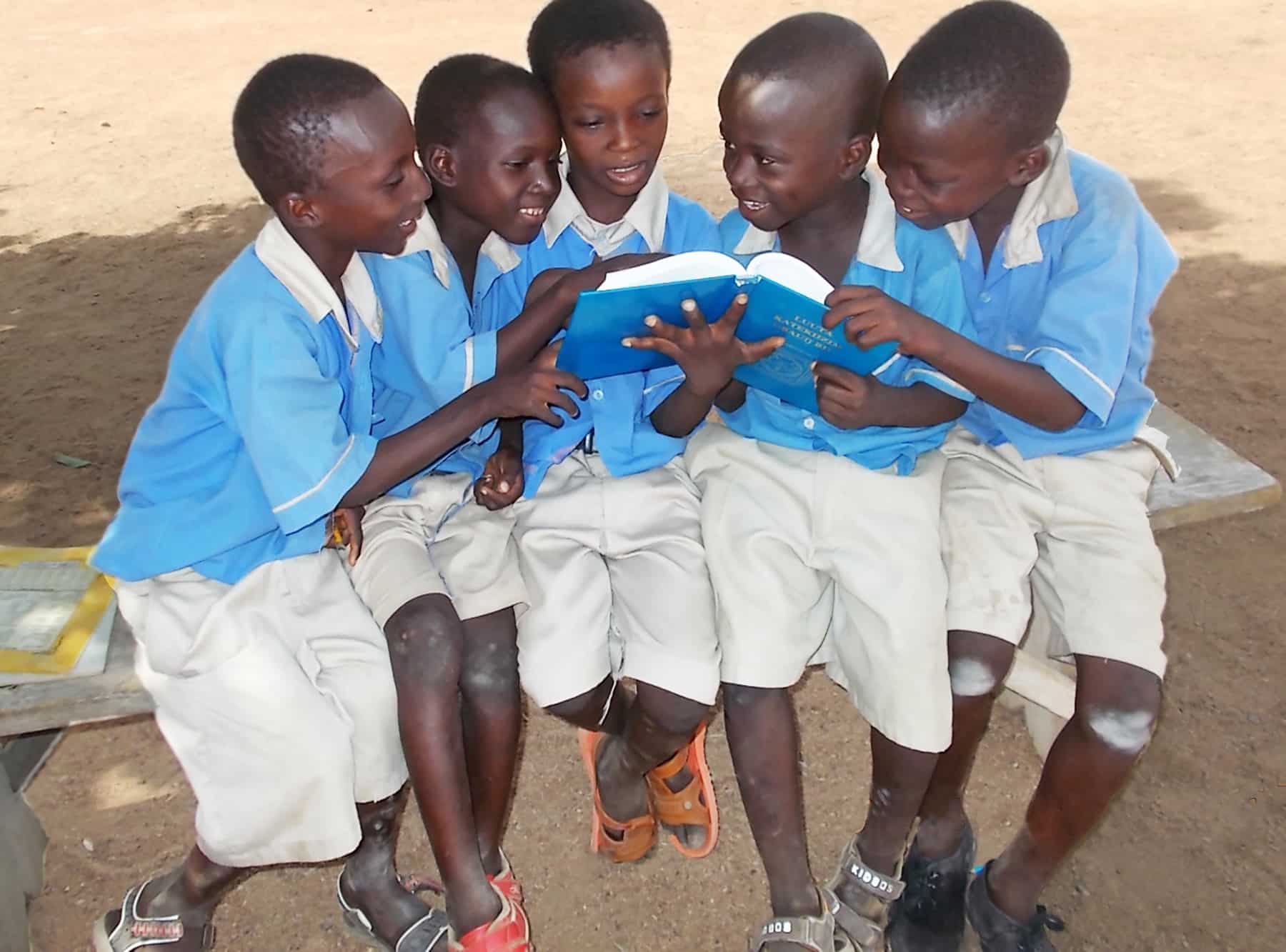 Ghana boys crowded around Luther's Small Catechism