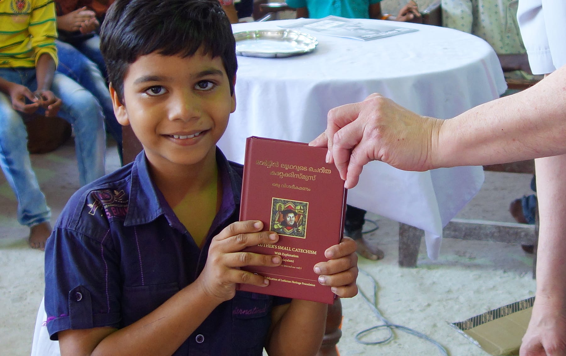 India Boy Holding Luther's Small Catechism