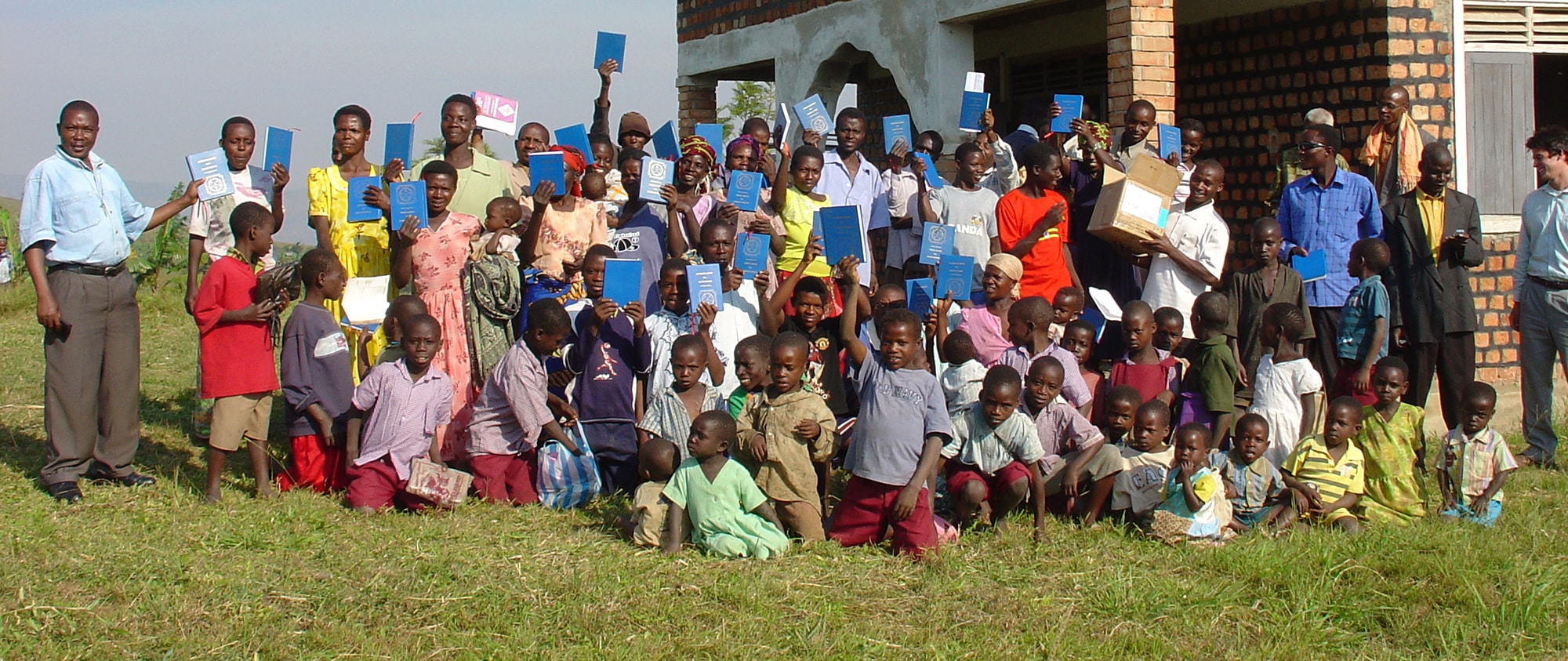 Uganda Group Outside Church Holding Up Luther's Small Catechisms