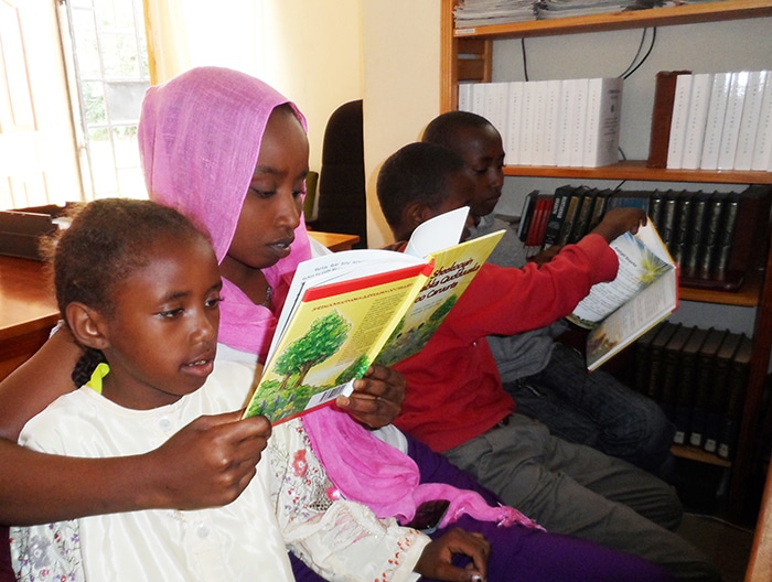 Somalian children reading A Child's Garden of Bible Stories