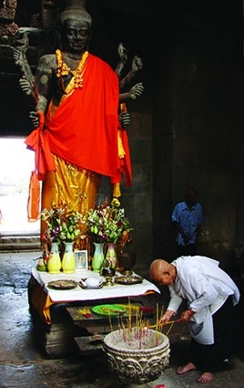 Buddhist Monk At Feet Of Buddha