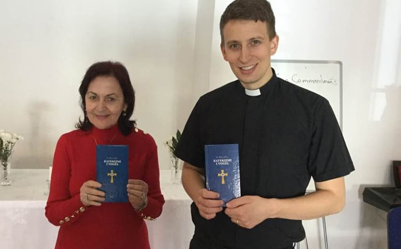 Man and woman holding Luther's Small Catechism