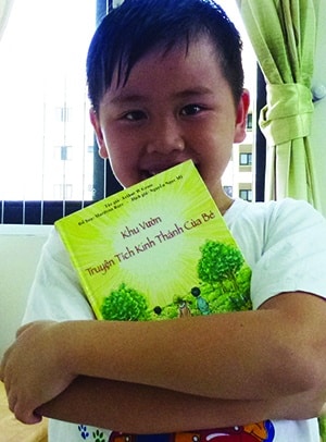 Vietnam boy Holding A Child's Garden Bible Stories