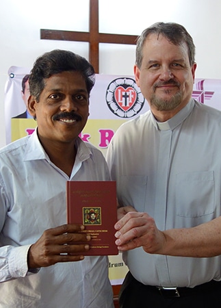 Indian Pastor Receiving Luther's Small Catechism From Matt Heise