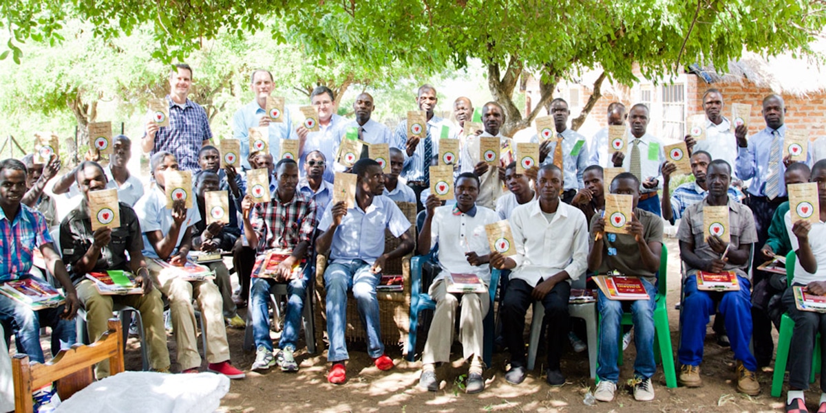 Mozambique men holding LHF books