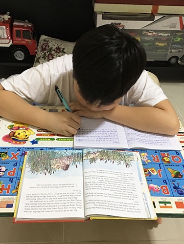 Vietnam child Copying Bible Storybook Pages