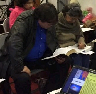Hispanic people reading Spanish Bible