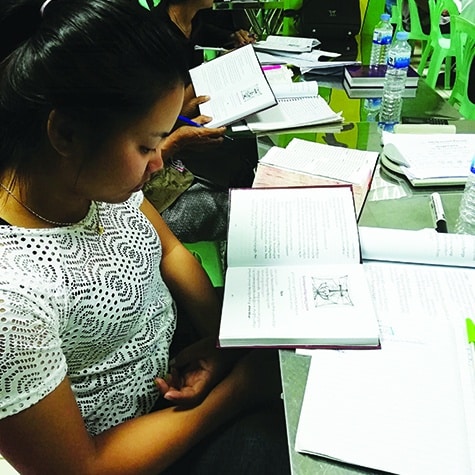 Cambodian girl reading LHF book