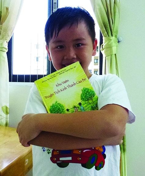 Danny, a young Lutheran in Vietnam, hugs his copy of the Vietnamese "A Child's Garden of Bible Stories," sponsored by the national LWML.